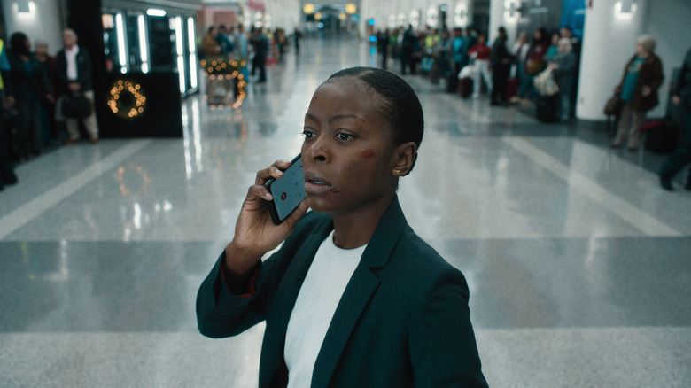 Danielle Deadwyler as Elena Cole on the phone in the airport in Carry-On