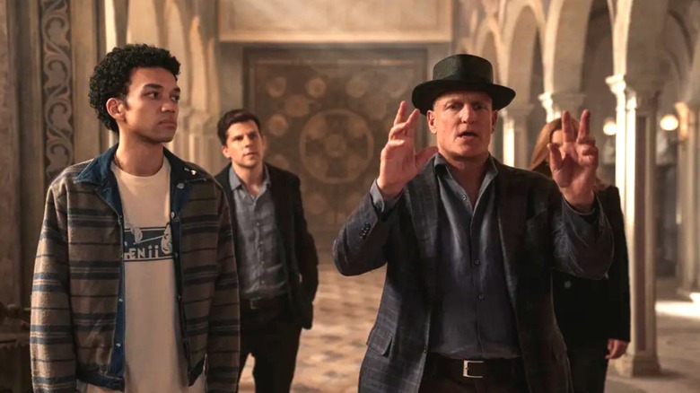 Charlie and Atlas walking behind Merritt who's gesturing in a hallway in Now You See Me: Now You Don't