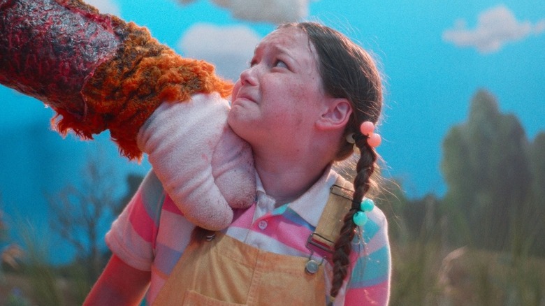 Delaney Quinn as Freddy looking up at Buddy the Unicorn with a scared look on her face in Buddy