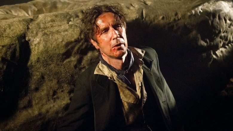 Paul McGann's eighth Doctor sitting injured on Doctor Who