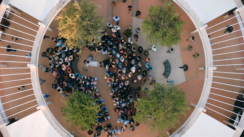 The hivemind, seen from overhead, circles Carol in Pluribus