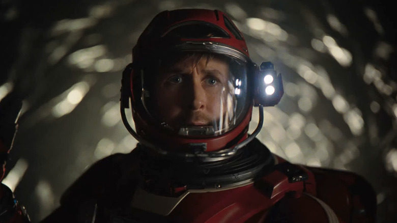 Ryan Gosling as Ryland Grace in his spacesuit walking down the tunnel to Rocky's ship in Project Hail Mary