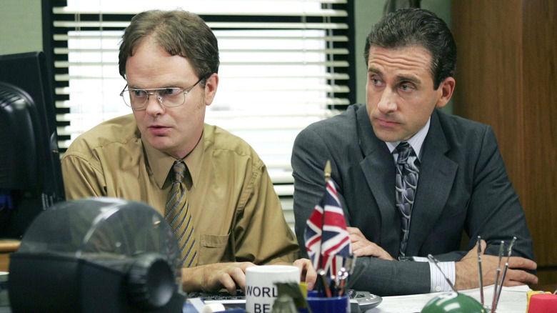 Dwight Schrute (Rainn Wilson) and Michael Scott (Steve Carell) sitting together in The Office