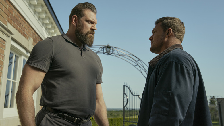 Reacher looks up at the gigantic Paulie in Reacher
