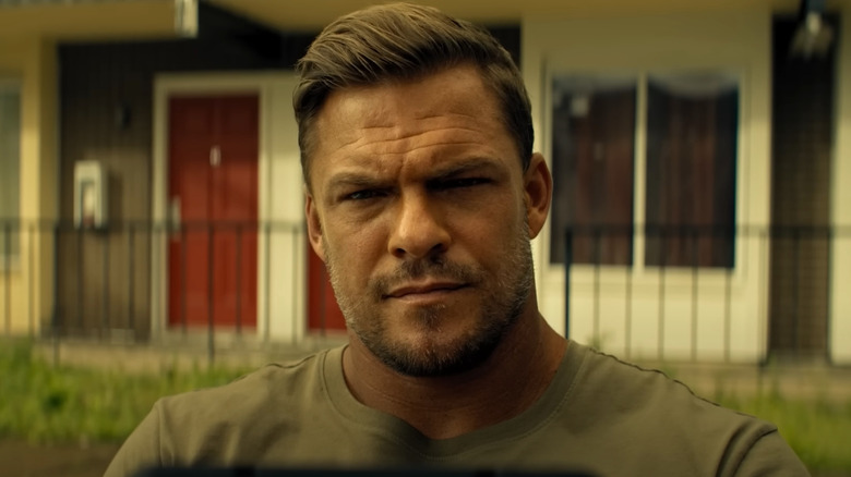 Jack Reacher staring intensely at something in Reacher