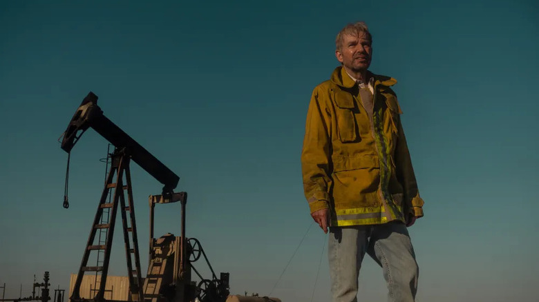 Tommy Norris next to an oil platform