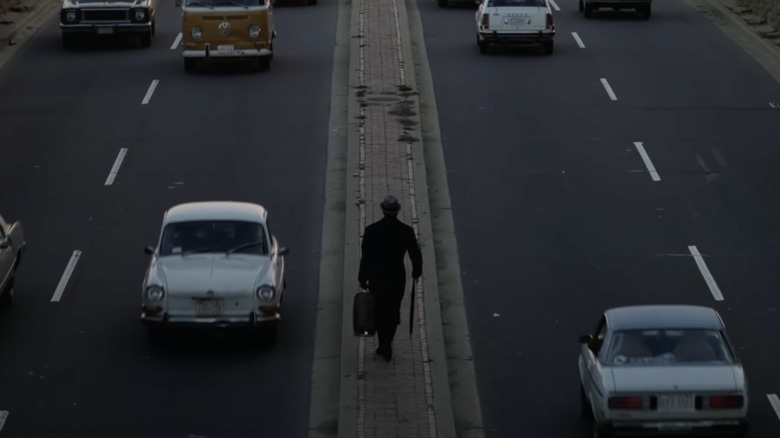 Chance walking on a traffic island in Being There