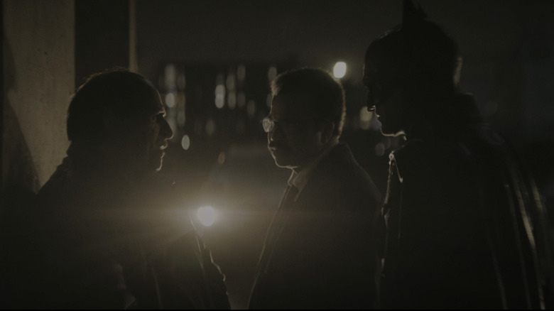 The Penguin is interrogated under an overpass by Jim Gordon and Batman in The Batman