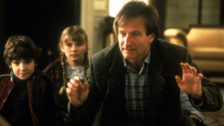 Bradley Pierce, Kirsten Dunst and Robin Williams in Jumanji