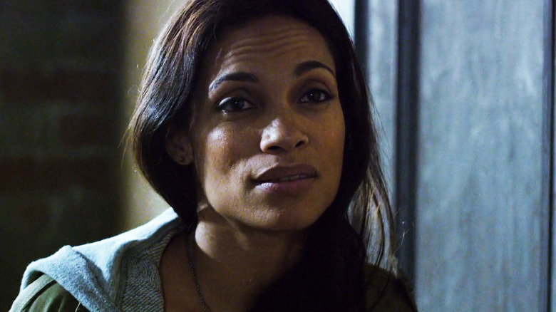 Rosario Dawson's Claire Temple stands by an apartment door in Daredevil