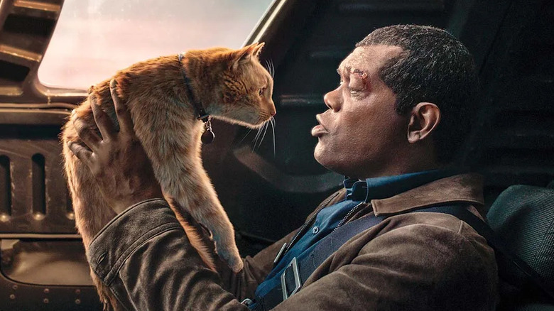 Nick Fury picks up Goose the Flerken in Marvel Studios' Captain Marvel.