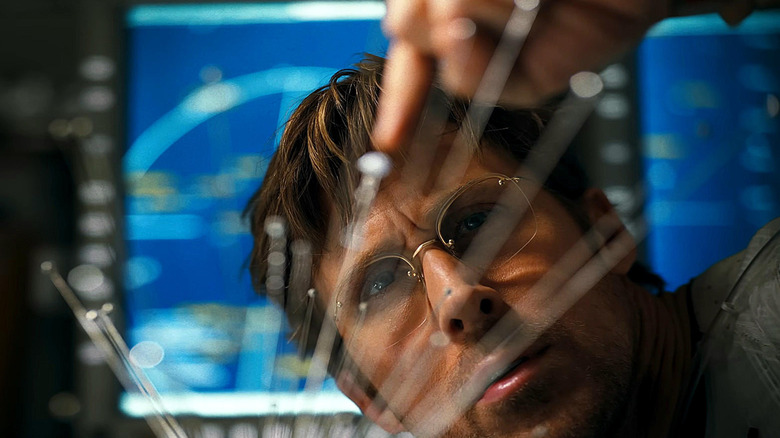 Ryan Gosling as Ryland Grace observing a model of the solar system in Project Hail Mary