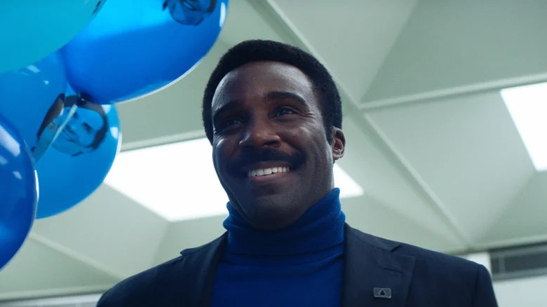 Tramell Tillman as Seth Milchick holding balloons on Severance