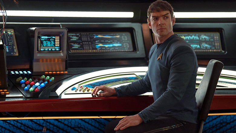 A seated Spock looks to his left on the bridge in an episode of Star Trek: Strange New Worlds