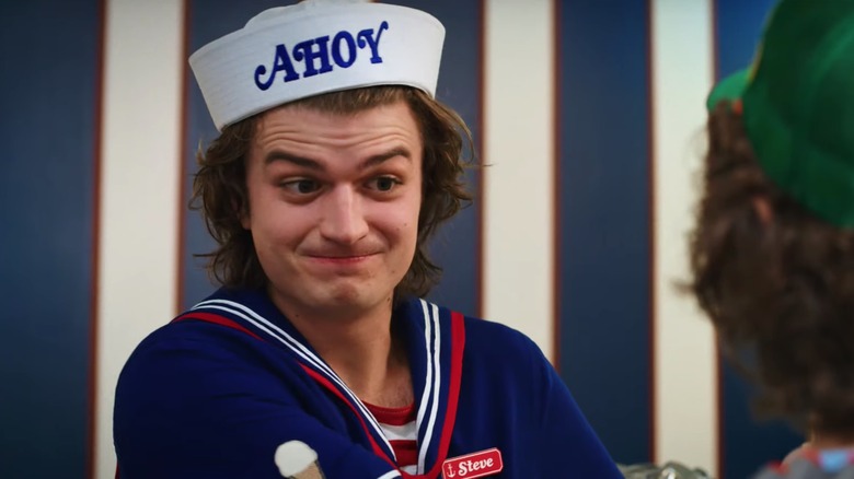 Joe Keery as Steve Harrington behind the ice cream counter in Stranger Things