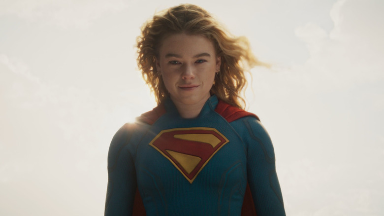 Milly Alcock as Supergirl floating and grinning in her costume at the end of Supergirl