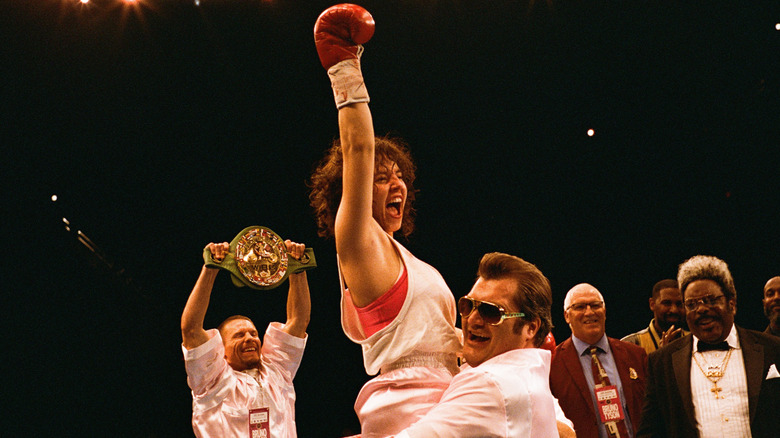 Sydney Sweeney as Christy Martin being held up in the boxing ring in Christy