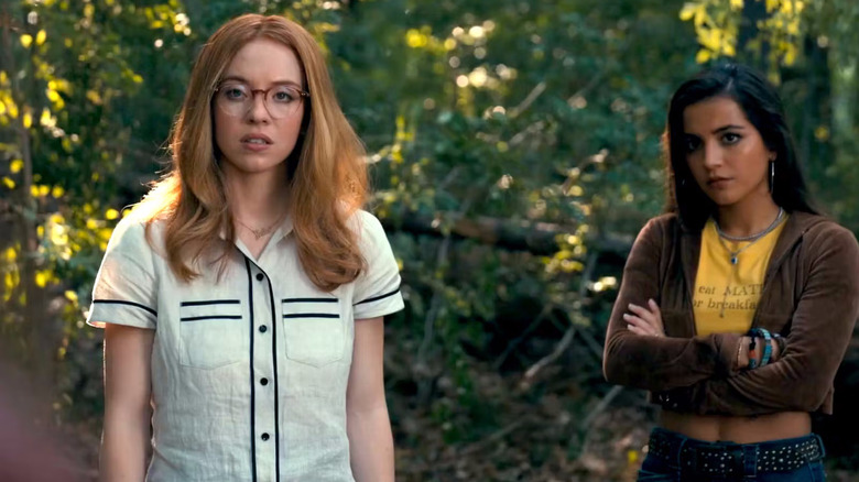 Julia and Anniya stand in the woods look skeptical in Madame Web