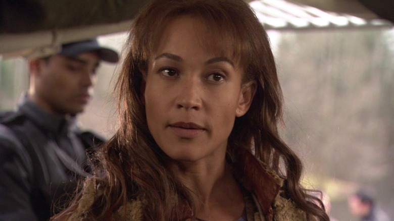 Teyla looks wary as she speaks to a crew member offscreen in Stargate Atlantis