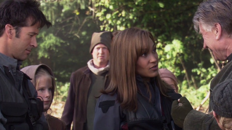 Sheppard and Teyla speaks to the inhabitants of a lush planet in Stargate Atlantis