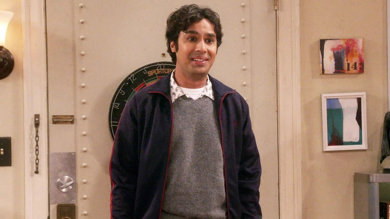 Raj in front of a door in the theory of the big explosion