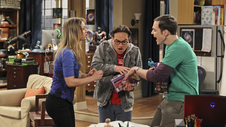 Sheldon and Leonard fighting over an action figure with Penny looking on in The Big Bang Theory