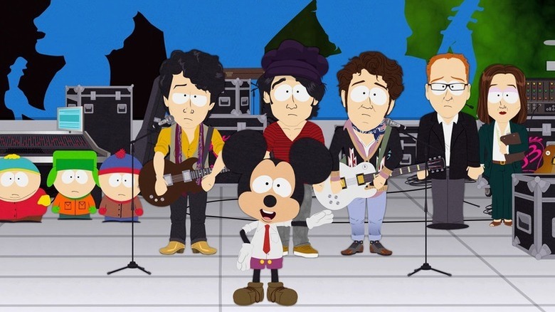 Cartman, Kyle, and Stan watch the Jonas Brothers and Mickey Mouse onstage on South Park