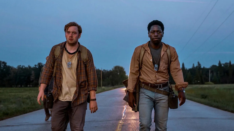 Ray and Pete, looking haggard, walking side by side at dusk in The Long Walk