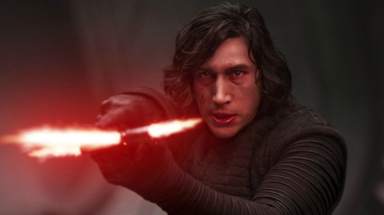 Kylo Ren pointing his red lightsaber