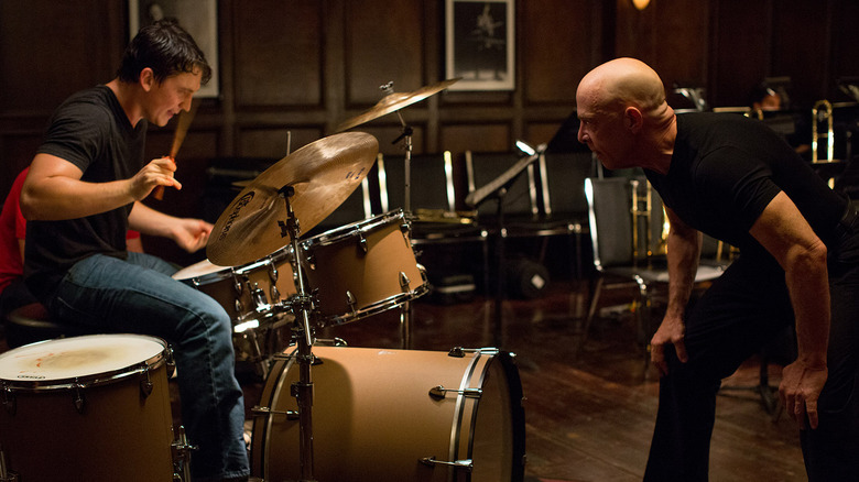 Miles Teller as Andrew Neiman anxiously drumming under the direction of J.K. Simmons as Terence Fletcher in Whiplash