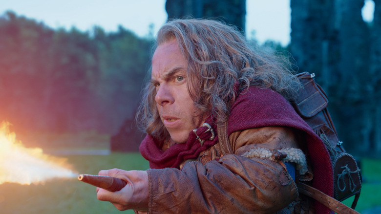 Warwick Davis shooting fire in Willow (2022)