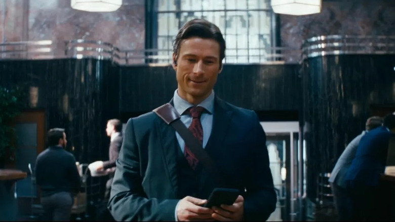 Becket listens to some tunes at work in How to Make a Killing