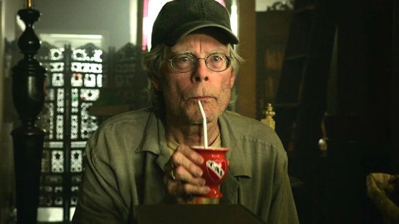Stephen King's shopkeeper sipping a drink in It Chapter Two