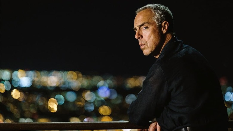 Titus Welliver as Harry Bosch leaning up against a railing looking over the city in Bosch