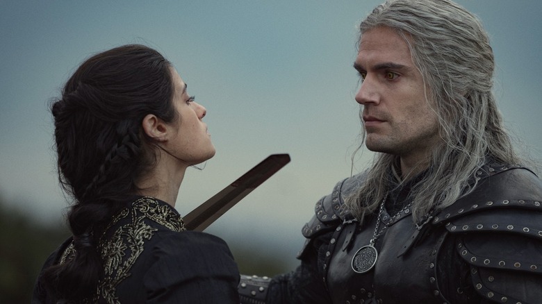 Geralt (Henry Cavill) holds a sword to the neck of Yennefer (Anya Chalotra) in The Witcher