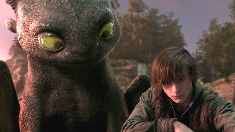 Tootless sitting by Mason Thames as Hiccup in How to Train Your Dragon (2025)