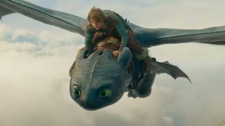 Hiccup (Mason Thames) flying on the back of the dragon Toothless in How to Train Your Dragon (2025)
