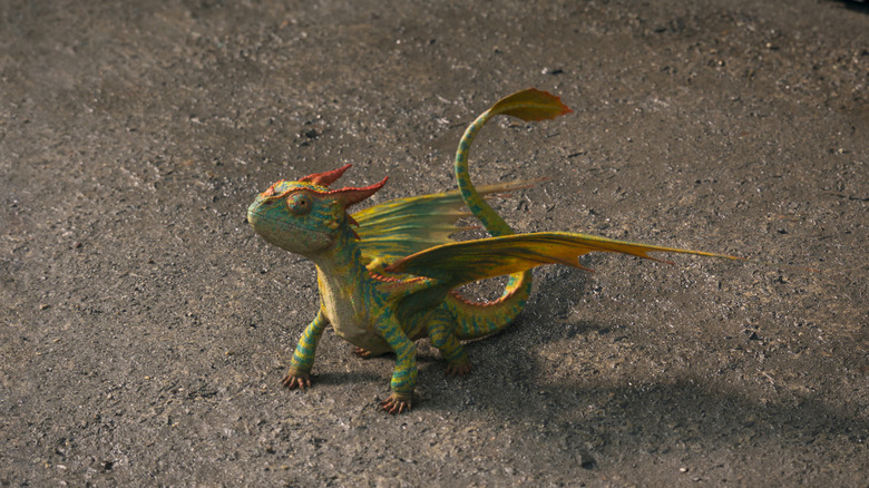 A small Terrible Terror dragon sitting on the ground in the How To Train Your Dragon remake