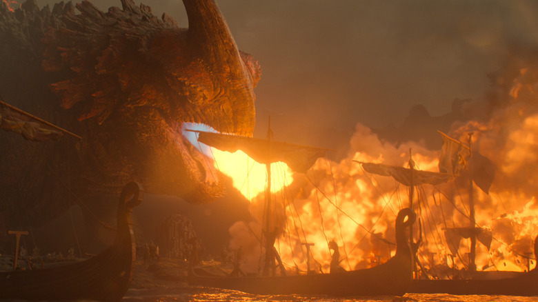 A giant Red Death dragon lighting an entire fleet of Viking ships on fire in the How To Train Your Dragon remake