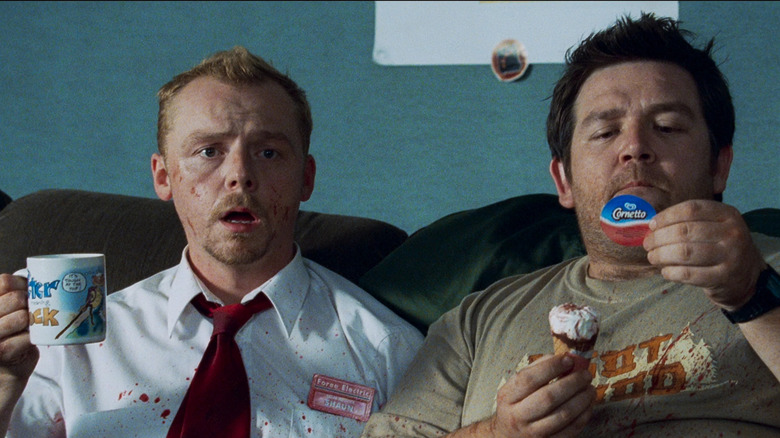 Shaun looking horrified (holding a coffee cup) while Ed enjoys a Cornetto ice cream cone in Shaun of the Dead