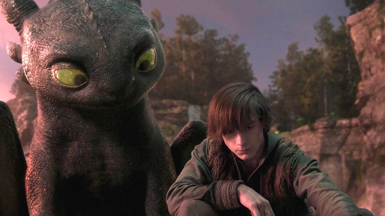 Toothless looking over Hiccup's shoulder