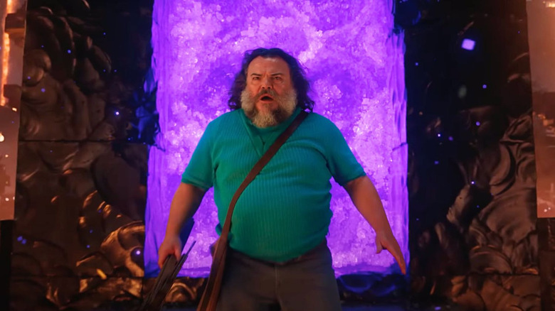 Jack Black as Steve standing in front of a purple portal in A Minecraft Movie