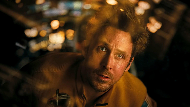 Ryan Gosling as Ryland Grace floating in a spaceship in zero gravity and looking out the window in Project Hail Mary