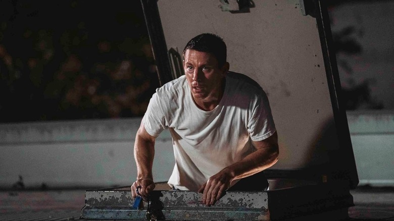 Jeffrey Manchester climbing onto a roof in Roofman