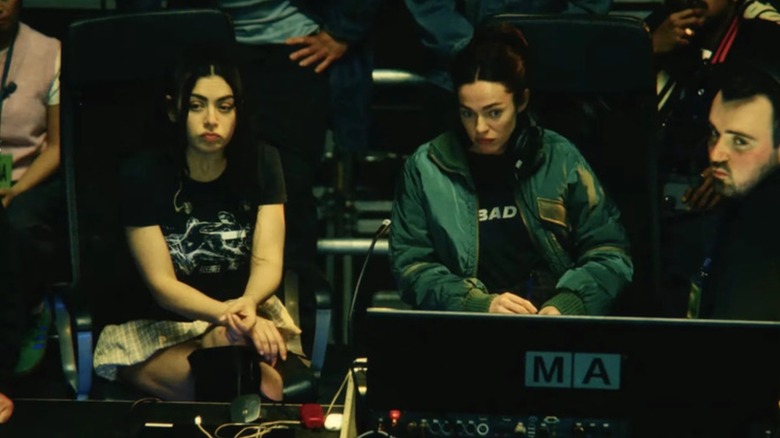 Charli and her team look worried about something in The Moment