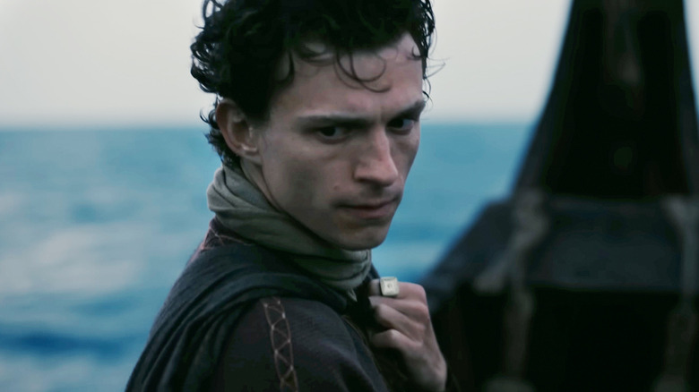 Tom Holland's Telemachus, looks sullen on a boat in The Odyssey