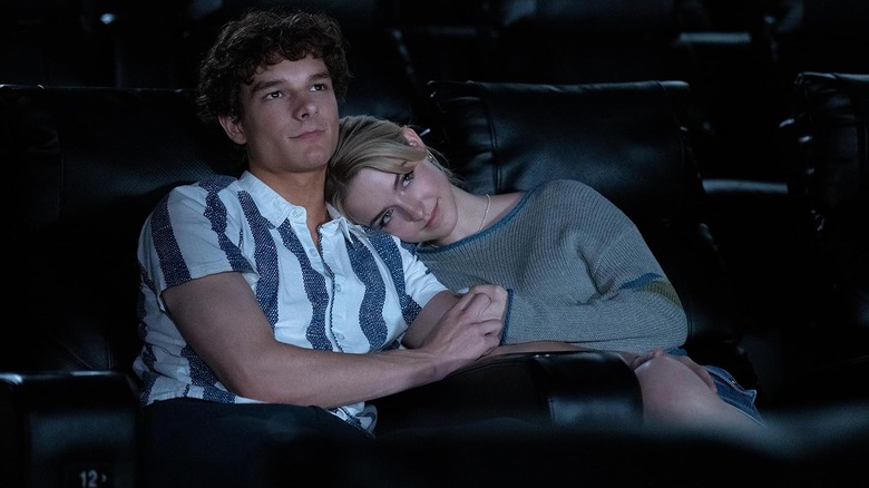 Mckenna Grace as Clara Grant and Mason Thames as Miller Adams snuggling in a movie theater in Regretting You