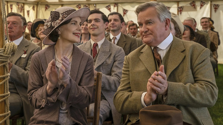 Elizabeth McGovern as Cora Crawley and Hugh Bonneville as Robert Crawley applauding in Downton Abbey: The Grand Finale