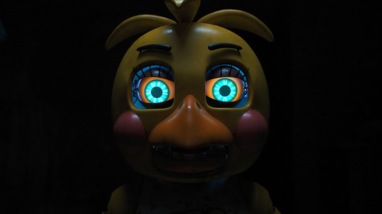 A close up of Toy Chica's face in the dark in Five Nights at Freddy's 2