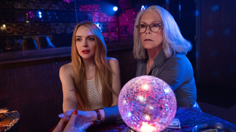 Anna and Tess holding hands with a fortune teller in Freakier Friday
